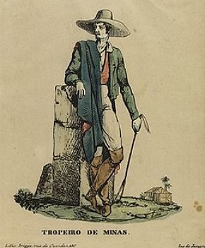 Ilustração mostrando um homem branco, magro, de chapéu com uma roupa verde e uma manta azul.